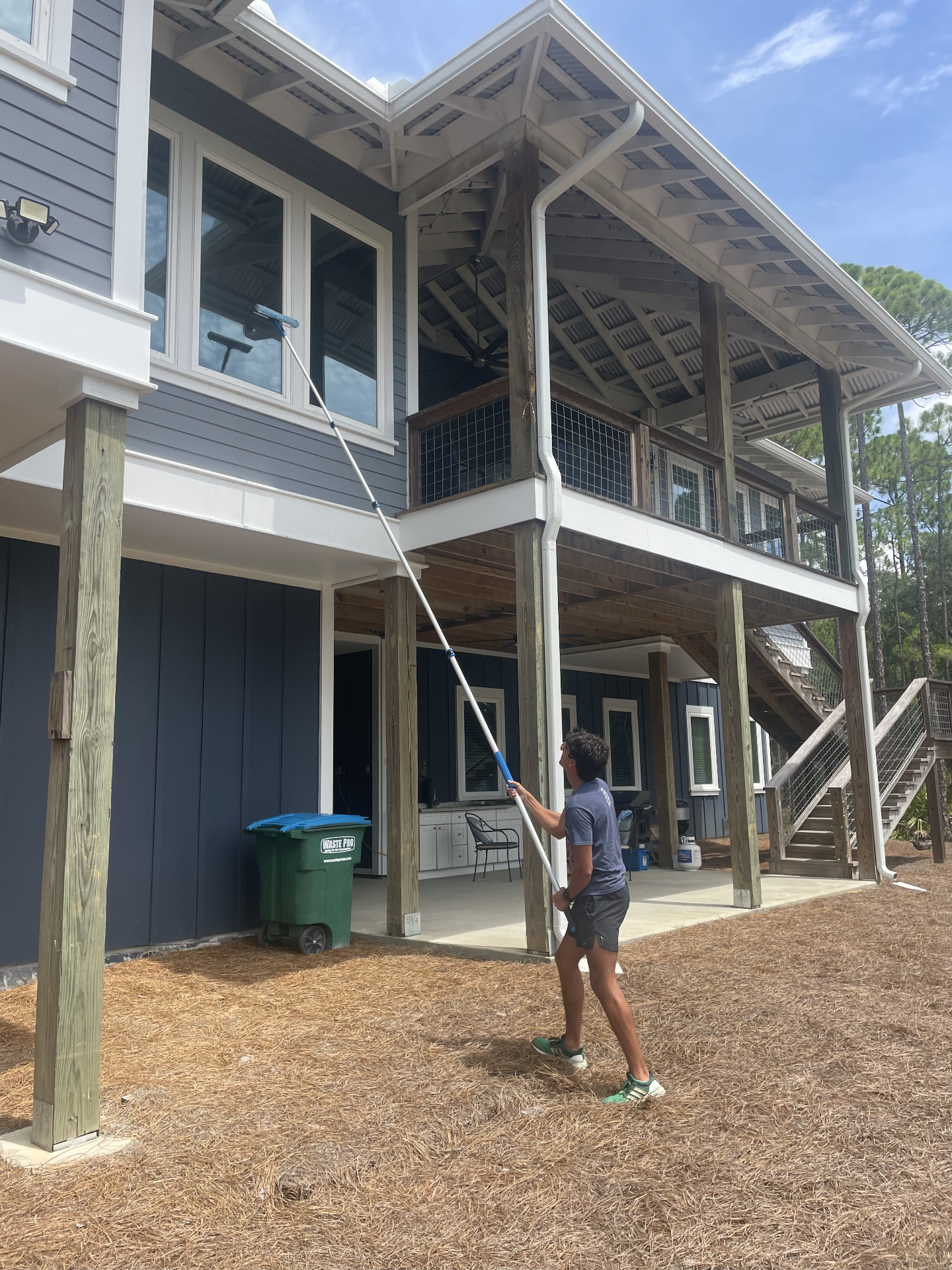 Window Wizards team member cleaning windows on a modern home
