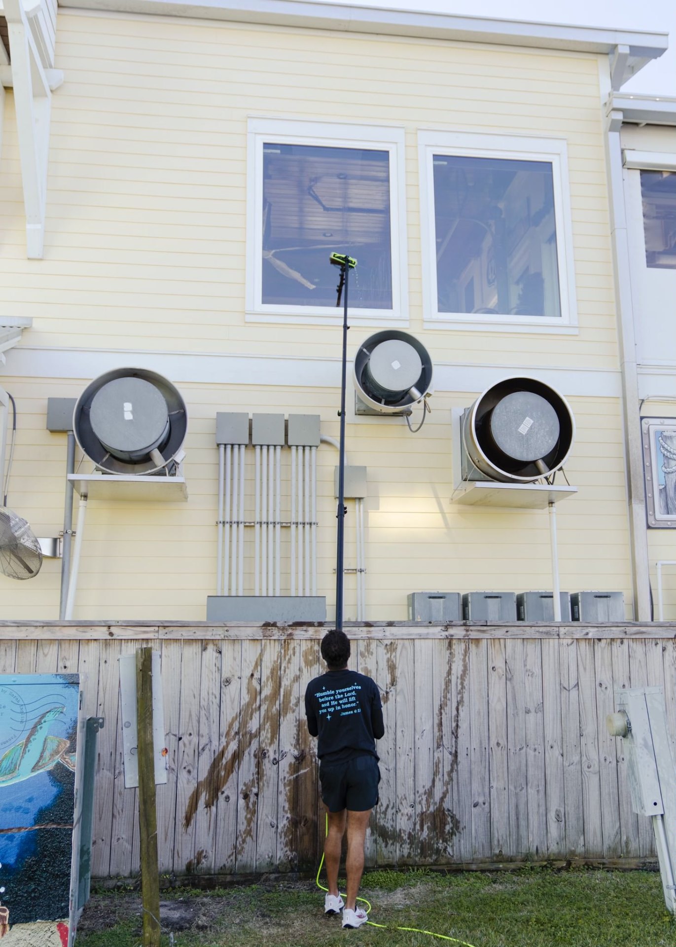 Water-fed pole cleaning on commercial building