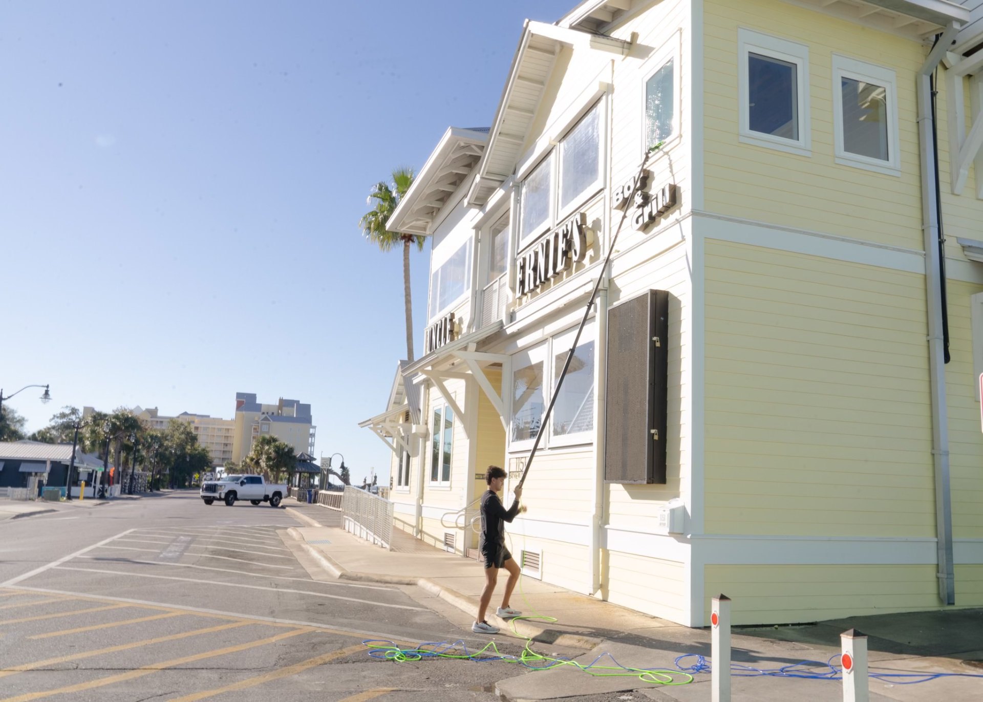 Window Wizards cleaning Uncle Ernie's storefront windows in Panama City