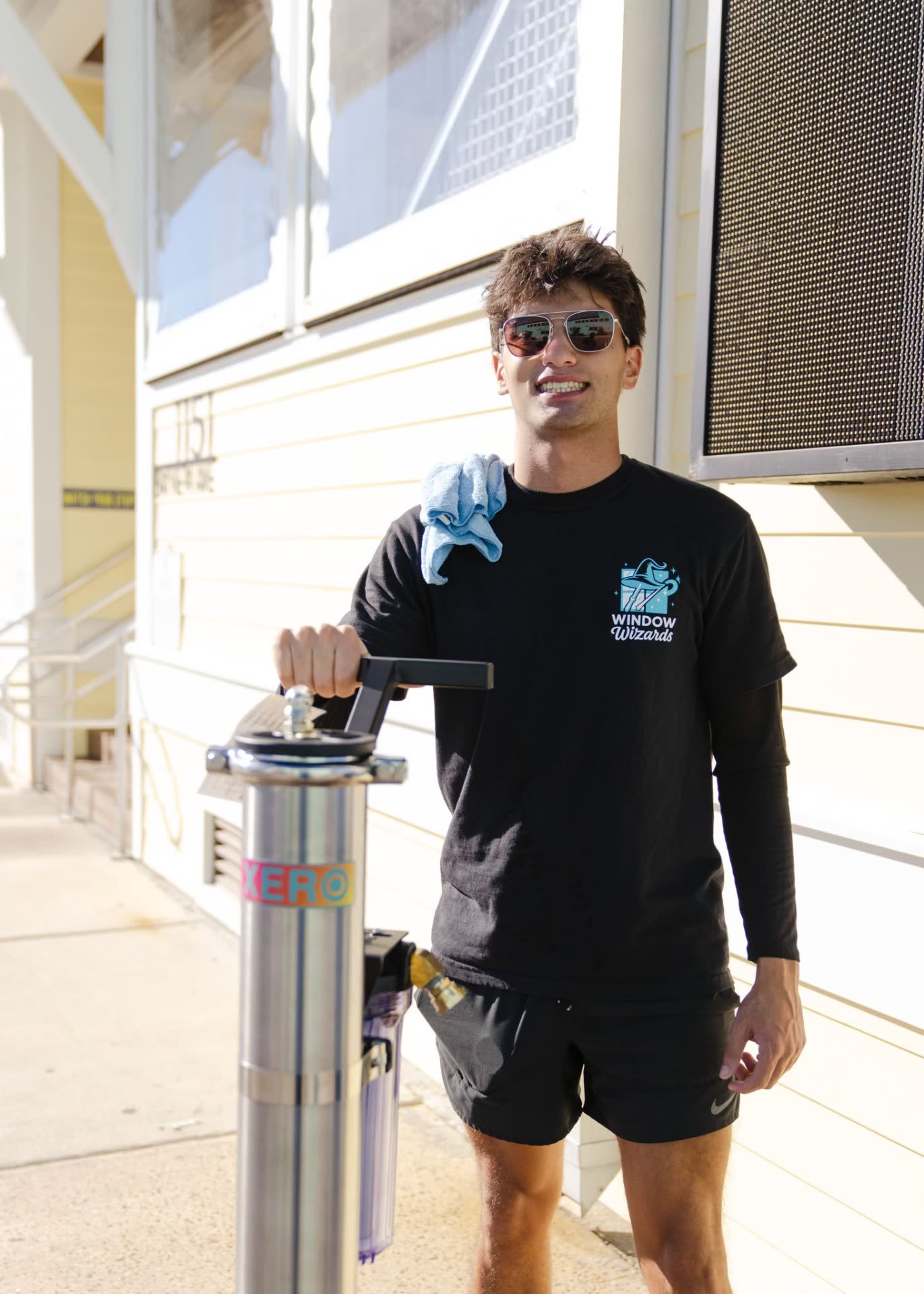 Window Wizards team member with professional cleaning equipment